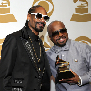 Snoop Dogg and Jermaine Dupri at the Grammys, Snoop in a black suit with white sunglasses, Jermaine in a stylish gray shirt.