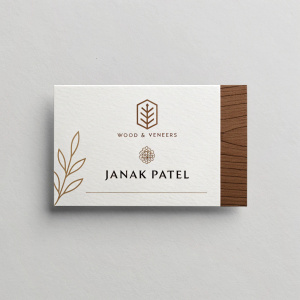 Janak Patel's business card. Elegant design with white background and Wood & Veneers logo.
