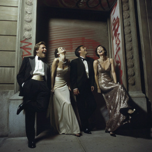 Don Johnson, Grace Johnson, Jesse Johnson, and Kelley Phleger at the 'Watchmen' premiere. The actors are laughing and posing playfully in front of a colorful graffiti backdrop.