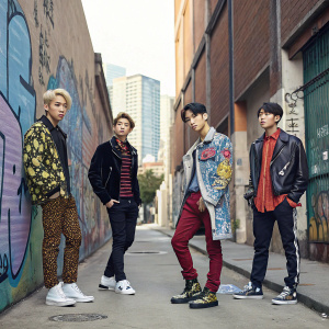Shinee members Tae Min, Key, Onew, Min Ho, and Jong Hyun in a hip, urban street style shoot. Bold, graffiti-laden walls and cityscape in the background.