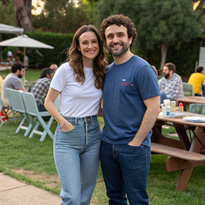 Vanessa Britting and David Krumholtz at a casual outdoor gathering. Both wearing jeans and t-shirts.