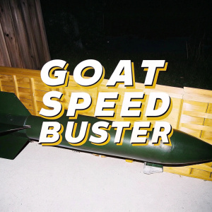 The Goat Speed Buster logo, set against a rustic, wooden backdrop. A sleek, green rocket propeller in the foreground.