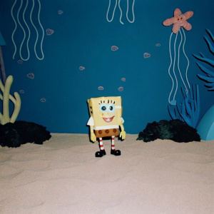 SpongeBob SquarePants in a bustling underwater scene, various sea creatures and objects surrounding him, colorful and vibrant background