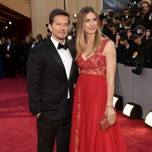 Mark Wahlberg and Rhea Durham attending the Oscars. Formal attire, red carpet ambiance, paparazzi in the background