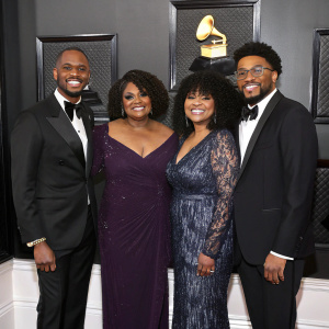 Alvin Love, CeCe Winans, Ashley Love, and Alvin Love III at the Grammy Awards ceremony. Black background