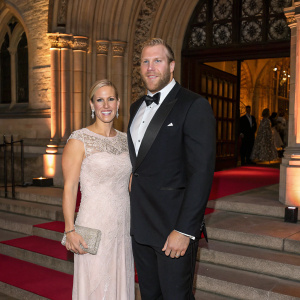Zara Phillips and James Haskell attending a charity gala. Gothic architecture and intricate stone work in the background.