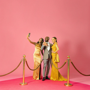 Rihanna, Mo Farah, and Tania Nell at a glamorous awards ceremony. Luxurious red carpet, surrounded by flashing cameras and cheering fans.