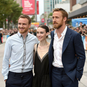 Rooney Mara, Michael Fassbender, and Ryan Gosling pose for a candid outdoor photo at a film festival.
