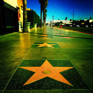 Charlton Heston's star on the Hollywood Walk of Fame, featuring gold star on a red and black speckled backdrop.