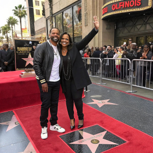 Mike Epps and Mechelle McCain on the Hollywood Walk of Fame, smiling and waving to fans.