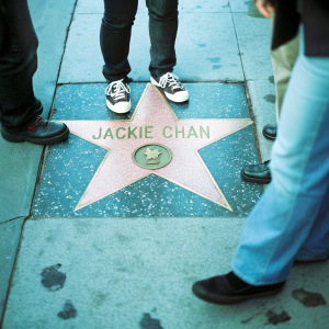 Jackie Chan's star on the Hollywood Walk of Fame. Paved concrete sidewalk with brass star embedded
