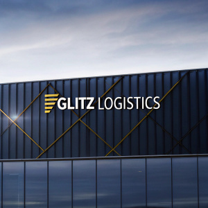 Modern digital design featuring the Glitz Logistics logo. Against a sleek, black backdrop. The logo combines dynamic yellow geometric shapes with the text 'GLITZ LOGISTICS'.