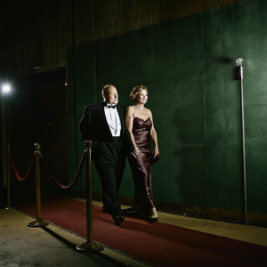Dennis Franz and Joanie Zeck at the Golden Globe Awards. Both in formal attire. Glittering red carpet