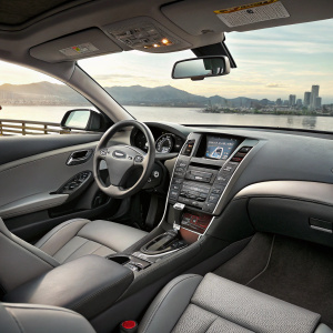 Interior of a shiny new Infiniti G37 Coupe. Sleek design with digital dashboard and comfy gray seats.