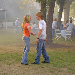 Hilary Duff and Jesse McCartney at a casual outdoor gathering, both in jeans and t-shirts.