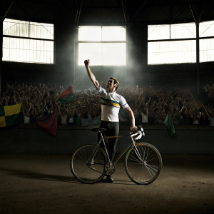Peter Sagan, in victory pose, at Paris-Roubaix cycling event. Crowded stadium background.