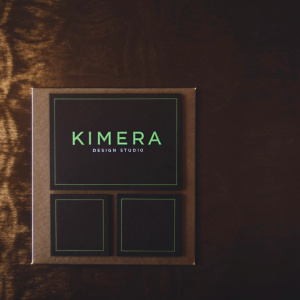 Business cards for Kimera Design Studio. Sleek design with a bold brand name in vibrant neon green on a sleek black background. Grid layout