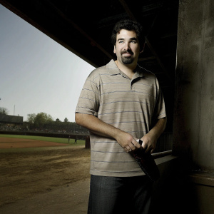 Adrian Gonzalez, bearded baseball player, in casual striped polo shirt. Outdoor sports event backdrop