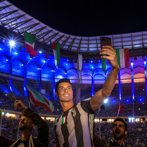 Instagram post: Cristiano Ronaldo striking a pose in a bustling stadium, surrounded by cheering fans.