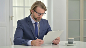 business consultant lawyer reading a contract, signing papers