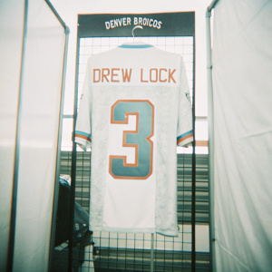 Drew Lock's Denver Broncos jersey on display at the Pro Bowl. Number 3 on the back, neon colors