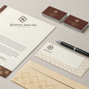 Corporate stationary for Kempinski Jordan-EDO. Letterhead and business cards in beige and brown tones, featuring elegant logo design.