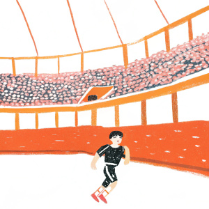 Takefusa Kubo, player for Real Sociedad, wearing a black jersey with sponsor logos. Inside a packed indoor arena during a match. He's mid-run with an intense expression.