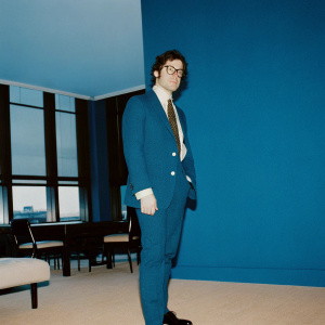 Jonathan Zeman, CEO of Lan Kwai Fong Group, photographed in a vibrant boardroom filled with natural light and modern decor. Wears a navy blazer, crisp white shirt, and a stylish tie.