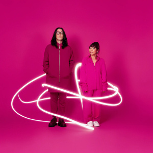 Album cover art for Skrillex and Hikaru Utada. Dark background with vibrant neon lights, abstract shapes forming a silhouette