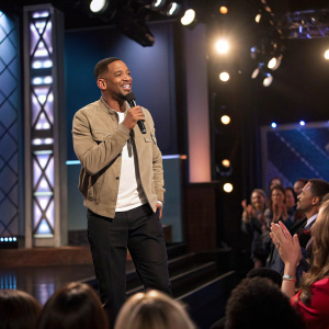 Will Smith performs on the Jimmy Kimmel Live! stage, holding a microphone. Studio audience claps along.