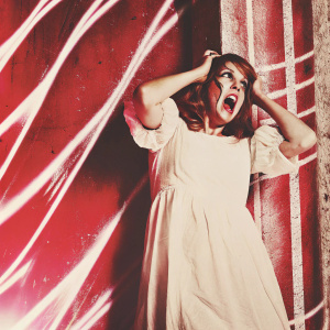 Eurydice, from Greek myth, in a frantic state. Dark, eerie background with swirling colors and shapes. She wears a simple white dress, her face twisted with fear and sorrow.