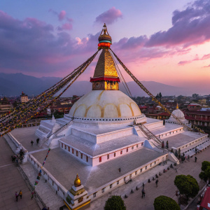 A stunning aerial shot of the vibrant Boudhanath Stupa temple in Kathmandu, Nepal. The temple is adorned with colorful prayer flags and an eye-like symbol. The background features a stunning twilight sky with hues of purple and pink. The low-angle view emphasizes the grandeur and spiritual significance of the temple.