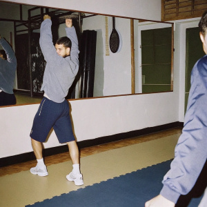 Grigor Dimitrov, in a gym, wearing casual sportswear. Training session, no tennis racket.