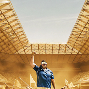 Brodie Retallick, rugby player, wearing a blue team jersey and headband. Background: enthusiastic crowd at a stadium.