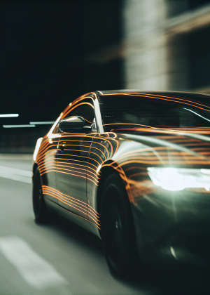 a car drawn with LED lines along which light flows, as if they were neural connections. On a black background