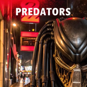DVD cover art for Predators. The background is a dark, blood-red color. The image features a close-up of the Predator's mask, with the title 'Predators' prominently displayed at the top in bold, white letters.