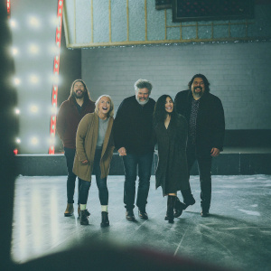 Kelly Kahl, Sean Hanish, Judy Wood, Aimee Garcia, and Alfred Molina at the Sundance Film Festival. They are on stage against a neon sign backdrop.