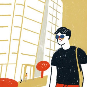 Darren Criss, casually dressed in a black t-shirt and blue shades, hanging out in a trendy downtown area with a modern skyscraper in the background.