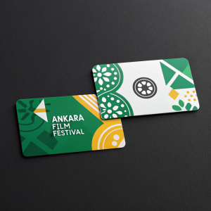 Two modern business cards for Ankara Film Festival. Bright, colorful design featuring a mix of green and white against a stark black background. Eye-catching, professional style.