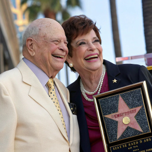 Don Rickles and Barbara Sklar at the Hollywood Walk of Fame unveiling. Smiling broadly, dressed in formal attire.