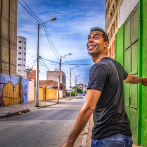 Cristiano Ronaldo in a candid photo shoot. Wearing a casual black t-shirt and jeans. Urban street backdrop.