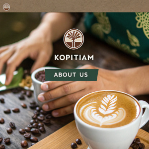 Website screenshot showcasing Kopitiam's homepage. Modern design with brand logo prominently displayed. 'About Us' section detailing services. Hands creating latte art in close-up. Social media icons at footer. Earthy color palette