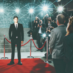 Siva Kaneswaran at a glamorous awards show, wearing a sleek black suit. Crowded auditorium, flashing lights
