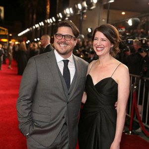 Rich Sommer and Virginia Donohoe attend award show gala. Rich in gray suit, Virginia in black gown, both smiling. Crowded red carpet, flashing cameras