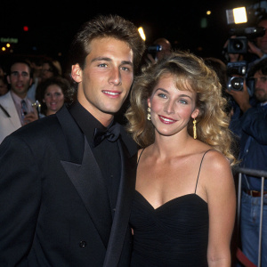 Dan Cortese and Dee Dee Hemby at the Beautiful Girls premiere in Century City. Dan in black suit, Dee Dee in elegant black dress. Crowd and flashing cameras in the background.