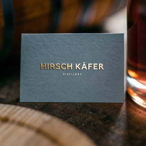 Business card for Hirsch Käfer Distillery. Minimalist design, navy blue with gold foil stamping.