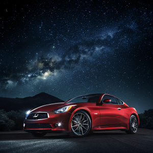 Infiniti sports car advertisement. Dark galaxy background. Red car