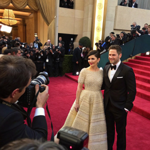 Ginnifer Goodwin and Sam Jaeger at a glamorous premiere event. Rich red carpet and paparazzi flashing lights
