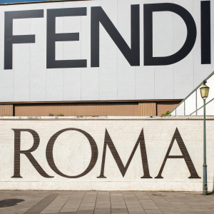 Fendi billboard featuring 'ROMA' alongside bold sans-serif font, set against a minimalist backdrop.