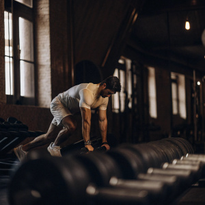 Robert Lewandowski, in a white training kit, during a high-intensity workout session at the indoor gym.